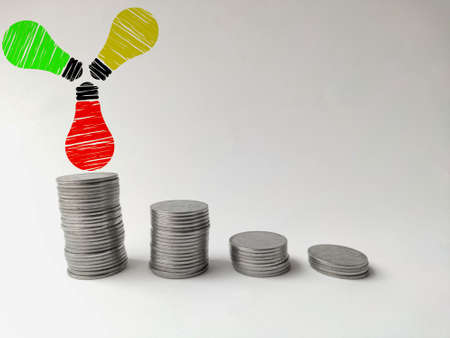 Increasing coin stack with bulbs idea and imagination conceptの写真素材