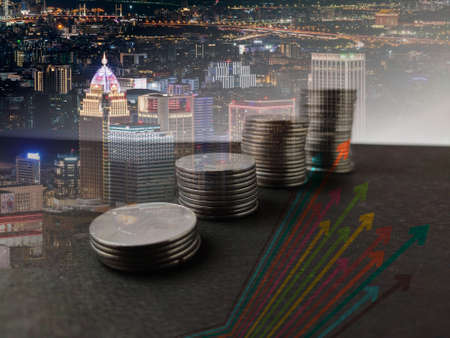 increasing trend of coins stack marked by Arrow with graphs and trend line double exposure high rise...