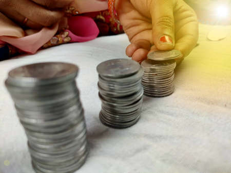 counting coins by stacking, woman hands holding coinの写真素材