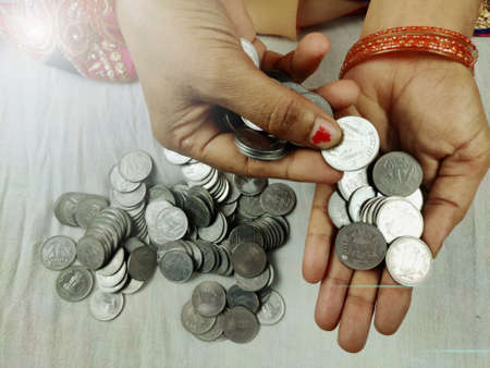 woman counting money indian currency Coins.の写真素材