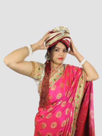 Turban or wreath worn by Indian woman in sari symbolising independent woman concept.の写真素材