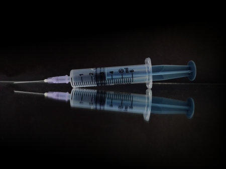 Medical Syringe with scale and Syringe islamer on black background with space for textの写真素材