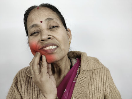 Indian Lady having health problem of toothache so put or touching hand on cheek expression of pain and sensitivity .の写真素材