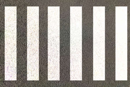 Zebra crossing made of stripes white and black lines painted on road for pedestrians crossing on busy traffic highwaysの写真素材