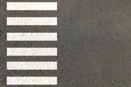 Zebra crossing made of stripes white and black lines painted on road for pedestrians crossing on busy traffic highwaysの写真素材