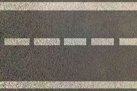 Road marking for lane driving , highways painted in white and yellow lines both direction traffic movement control by use of sign and symbols of trafficの写真素材