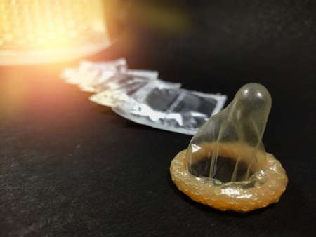 Male contraceptive Method Condom kept before Packets on black background with space for text.の写真素材