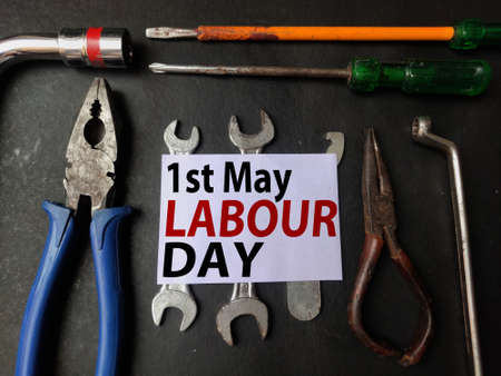 May 1st , Labour day poster with tools on Black background , text written in center.の写真素材
