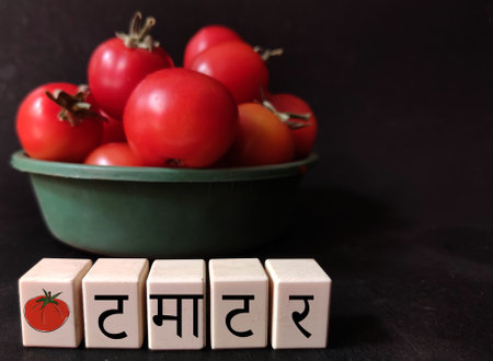 Tomato kept in plate on black background with Text on Wooden blocks space for text available
