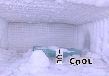 Ice background of refrigerator freezer with ice cube tray , white background with blocks written ICE...