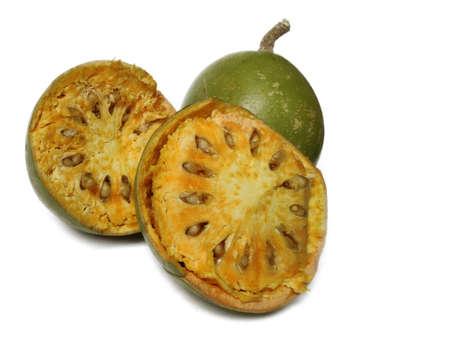 Wood Apple or Aegle Marmelos is an India. continental tropical fruit with hard cover and soft pulp on white backgroundの写真素材