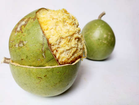 Wood Apple or Aegle Marmelos is an India. continental tropical fruit with hard cover and soft pulp on white backgroundの写真素材