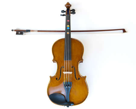 wooden children violin for learning to play music, fiddle and stick making a crossの写真素材