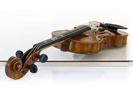 wooden classic violin lying on itの写真素材