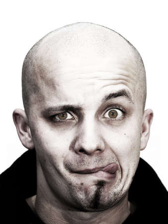 young bald head teenager makes grimace with tongue outside and beard at his chin on white background