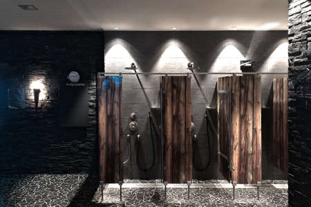 modern shower in a swimming pool with optical wooden plexi glass dividerの写真素材