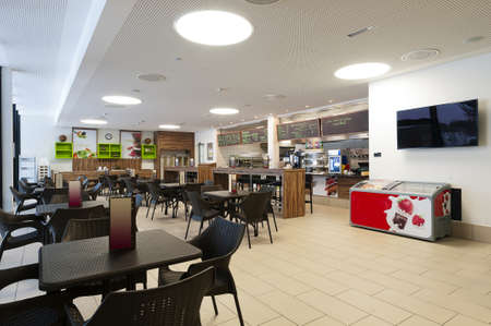 large self service restaurant with wood and rattan interior and long readout barの写真素材