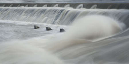 river water step with flowing water and spume with concrete elementsの写真素材