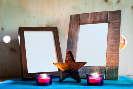 two wooden picture frames in front of candle light and starの写真素材