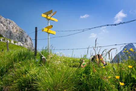 hiking girl relaxing on green mountain meadowの写真素材