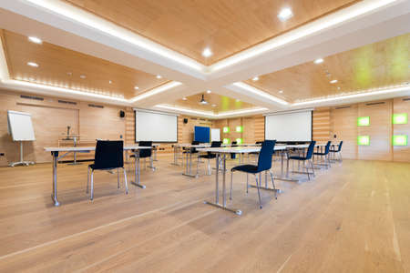 flipchart and projection screens in wooden conference roomの写真素材