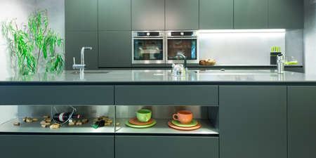 frontal view of modern anthracite kitchen with decorationの写真素材
