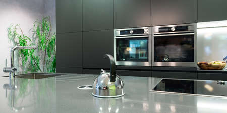 detail over work plate of modern kitchen with teapot and baking ovenの写真素材