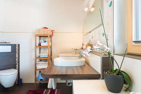 detail of basin on wooden board with decoration in bathroomの写真素材