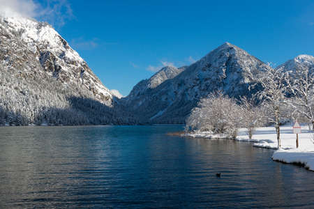 cold mountain lake in austrian alps at winterの写真素材