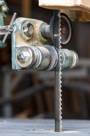 detail of fixed bandsaw blade with table and lead rollsの写真素材