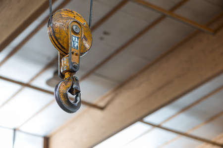 yellow clevis sling load hook with latch of carpentry workshopの写真素材