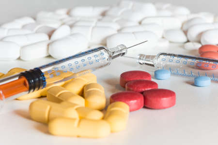 medical colored pills and injection on white backgroundの写真素材