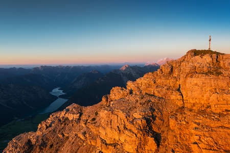 orange rough rocks of mountain at sunset light at fallの写真素材