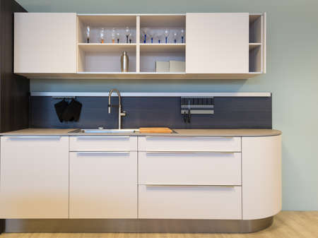 nice small beige kitchen kitchenet with sink and wall unitの写真素材