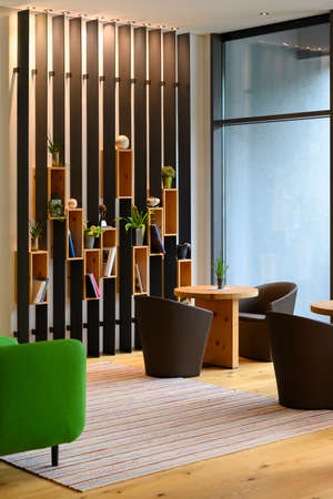 vertical metal shelf plant and book decoration on wooden boards boxes in indoor lobbyの写真素材