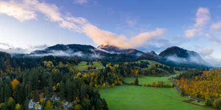 landscape with sky and mountain forest panorama at fall autumn in reutte austriaの写真素材