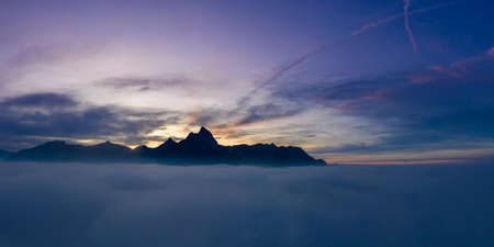 over cloud carpet with hahnenkamm mountains at misty sunset at reutteの写真素材