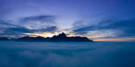 cloudy sunset panorama over clouds with view to mountain chain hahenkamm at reutteの写真素材