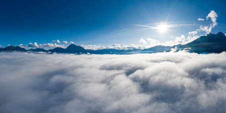 landscape with sun beams in alps of reutte above cloud bankの写真素材