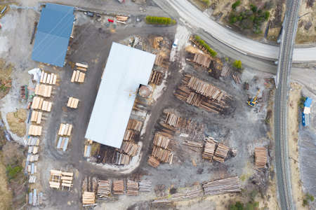 aerial drone view from top to sawmill with tree wood trunk staples aroundの写真素材