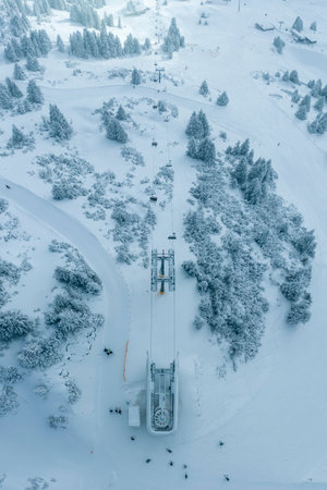 chair lift from above in fresh snowy winter in tourist ski resortの写真素材