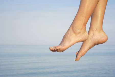 Two heels against a background of blue waterの写真素材