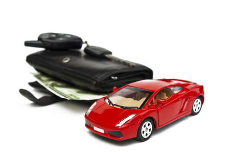 Money and car keys on a white background isolatedの写真素材
