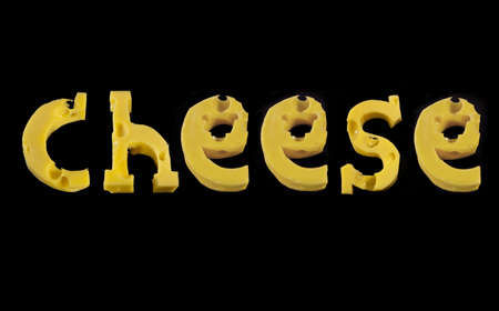 Word Cheese from pieces of cheese isolated on blackの写真素材