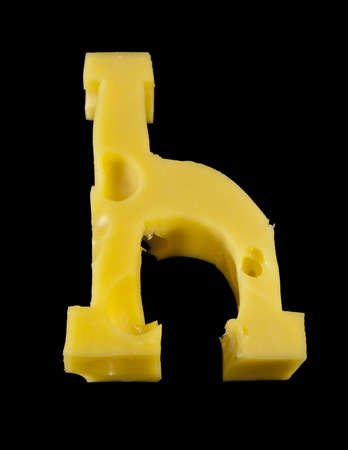 Letter H from cheese piece isolated on blackの写真素材