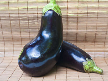 Two eggplants on wood background