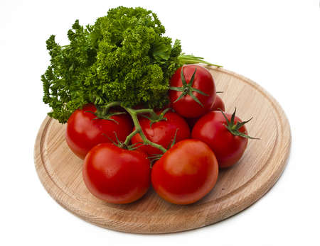 Tomatoes on a cutting board isolated over whiteの写真素材
