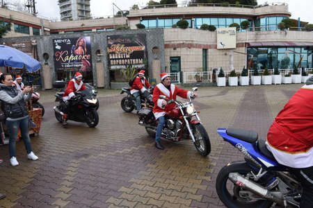 The parade of Santa clauses, a carnival procession and the celebration of New Year in Sochi, Russia, 24 December 2015. The area of the marine station.のeditorial素材