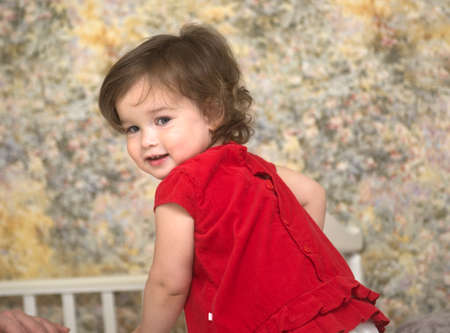 Portrait of a beautiful little girl in the roomの写真素材