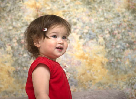Portrait of a beautiful little girl in the room